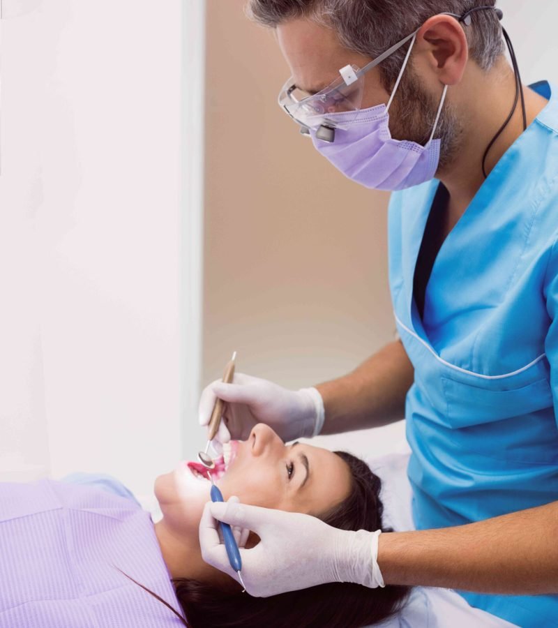 dentist-examining-female-patient-with-tools_optimized